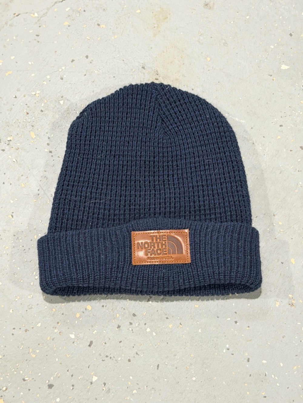 The North Face Navy Knit Cuffed Beanie with Brown Leather Logo